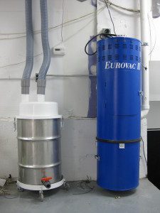 Wallmounted blue Eurovac vacuum and a wet separator