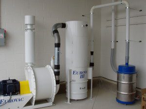 Eurovac white central vacuum and wet separator installed in a dealership